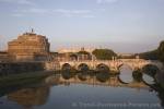 The historic St Angel Bridge leads across the Tiber River to the St Angel Castle in the city of Rome, Italy - these structures date date back to around the years 120-140 AD.