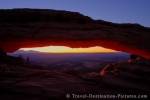 The horizon seen through Mesa Arch in Canyonlands National Park is ablaze with color during one of the most magical times of day - sunrise.