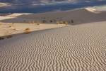 A basin of beautiful white sand with ripples and formations caused by the winds and rain of nature as it sweeps over White Sands National Monument in New Mexico, USA.